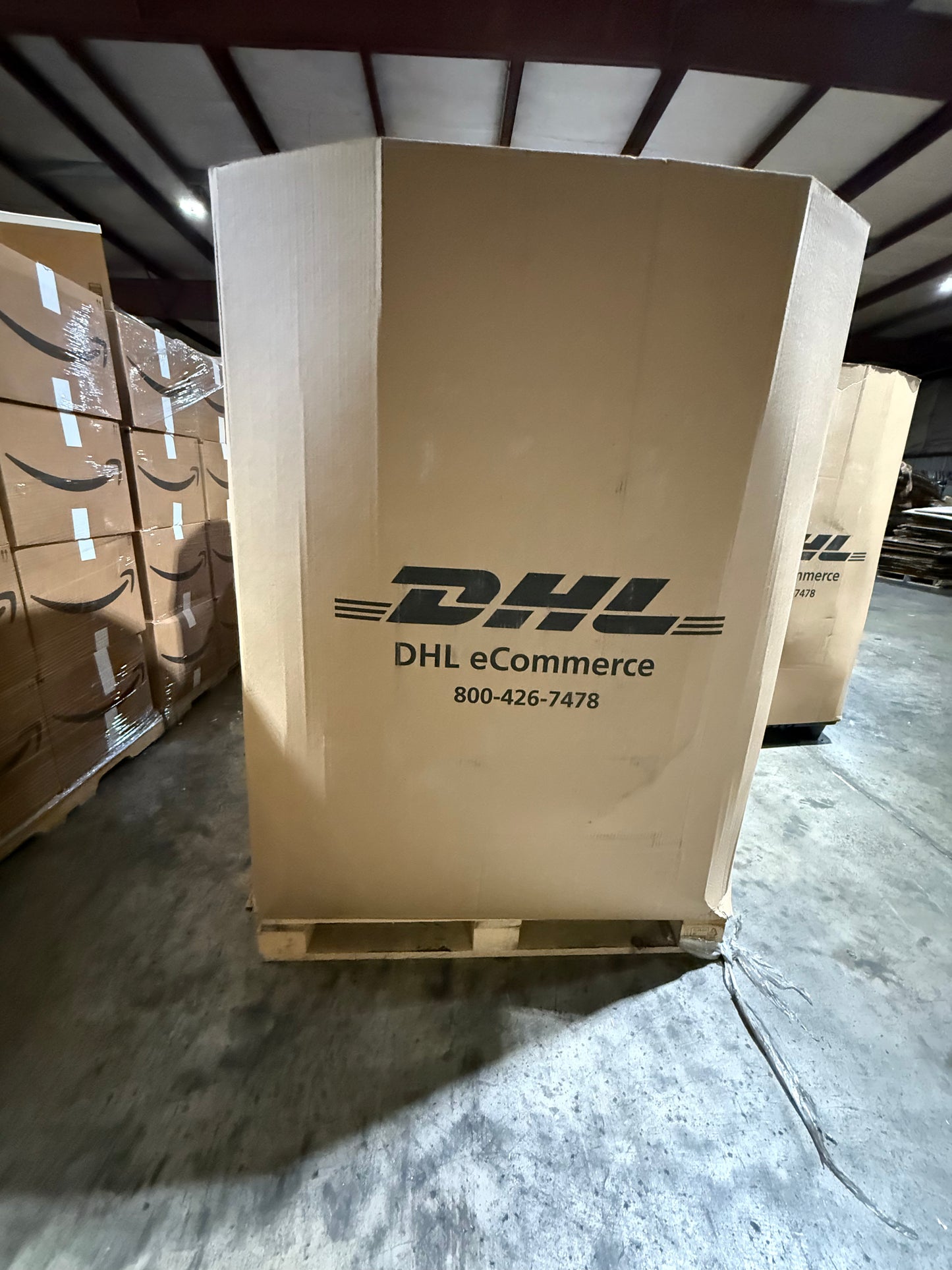 Large cardboard box with DHL logo in a warehouse setting